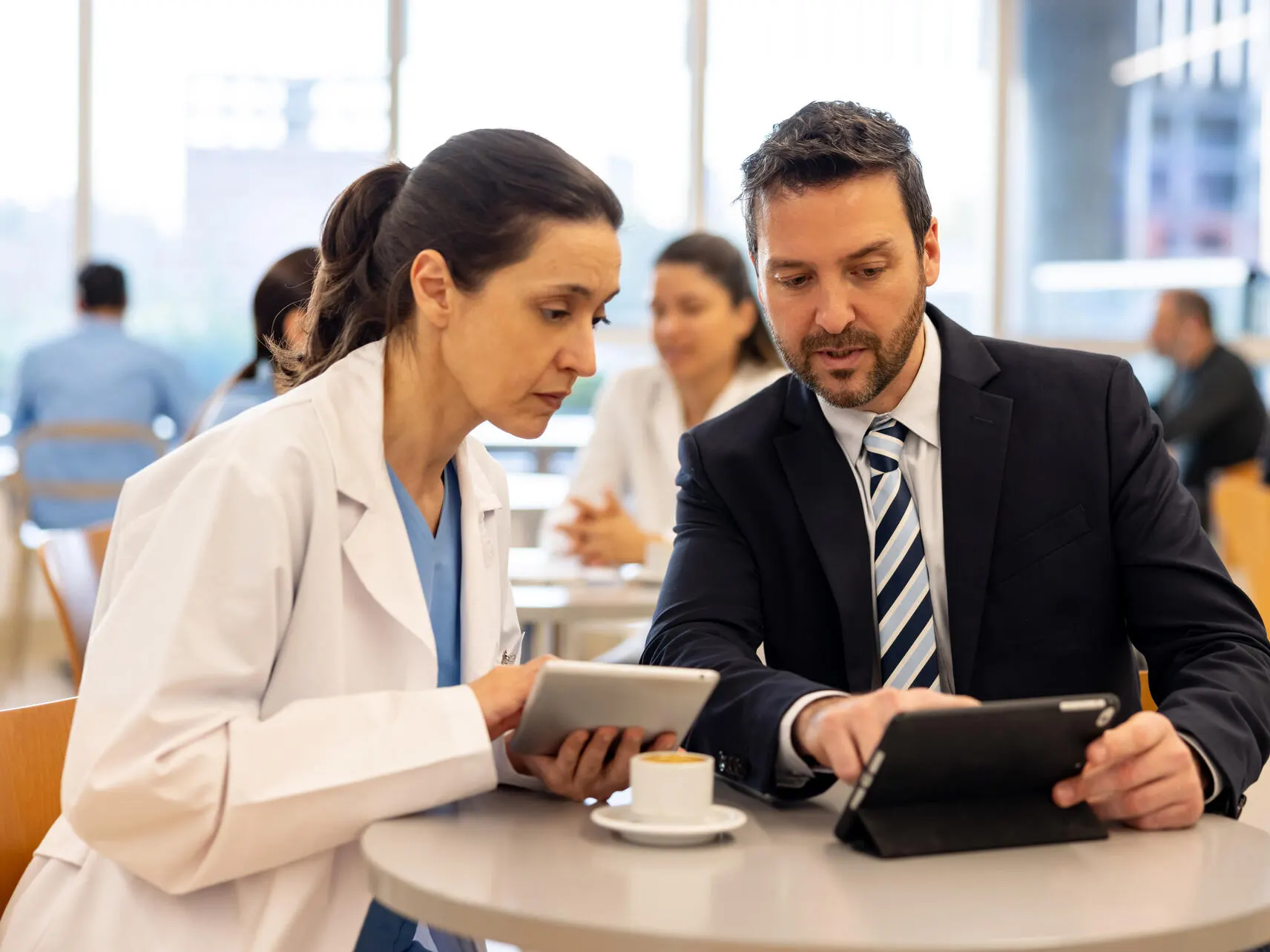 A physician and businessperson have a discussion