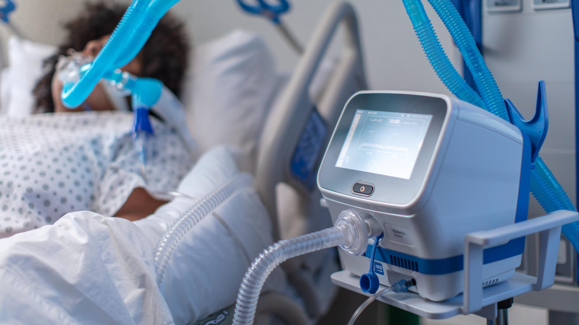 Woman intubated in hospital room