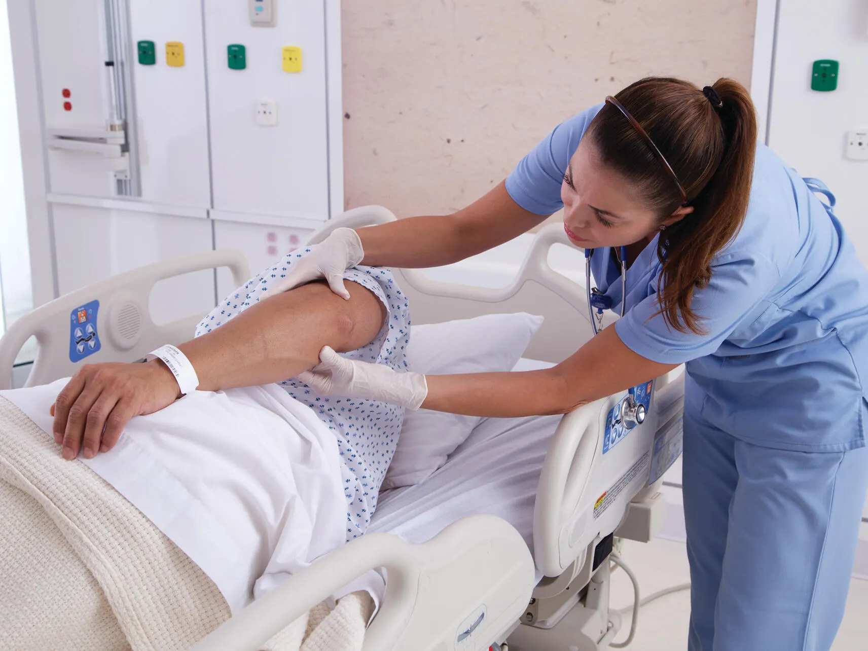 Nurse looking over patient