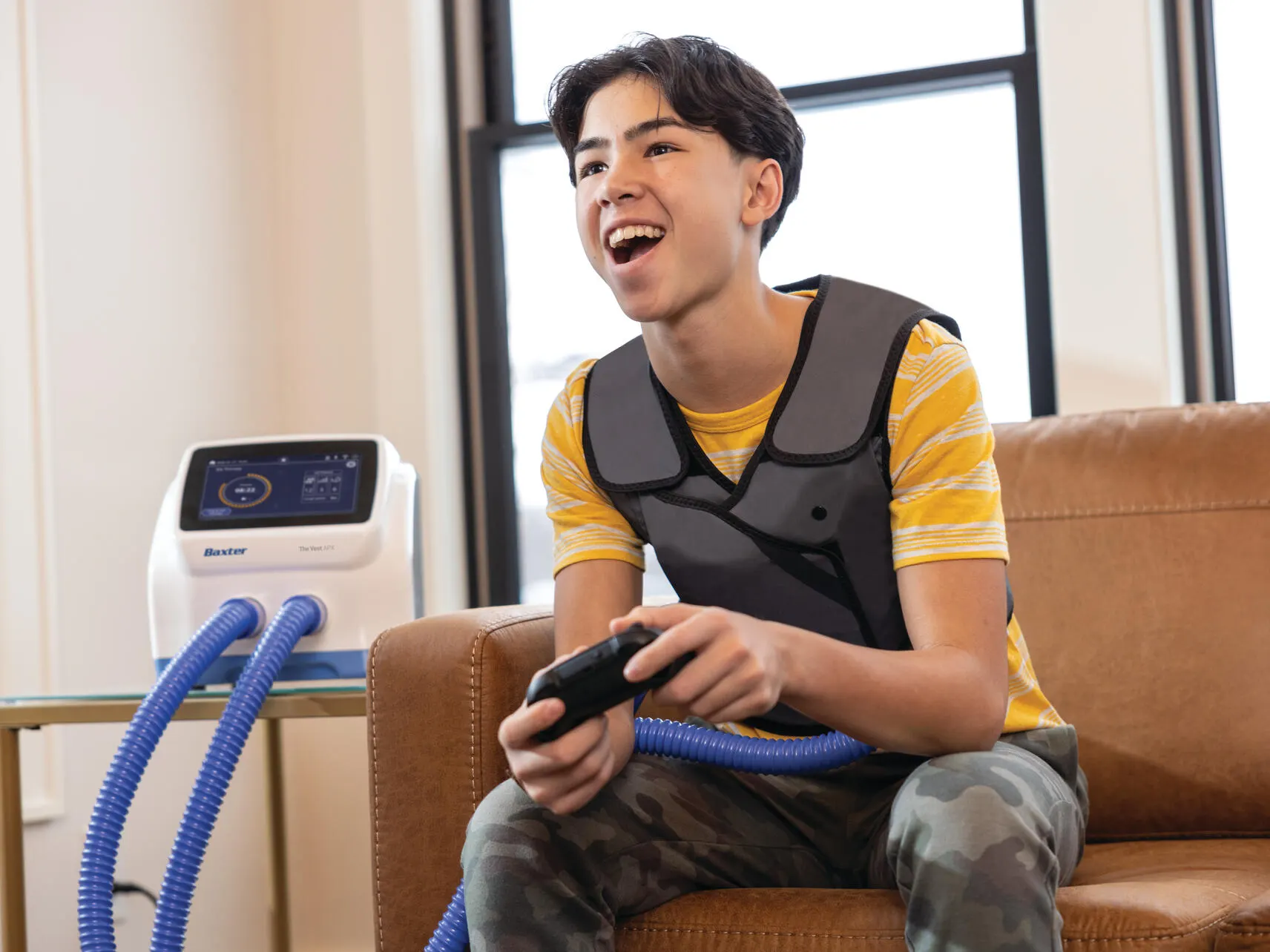 Teenager playing a games console at home while wearing The Vest APX