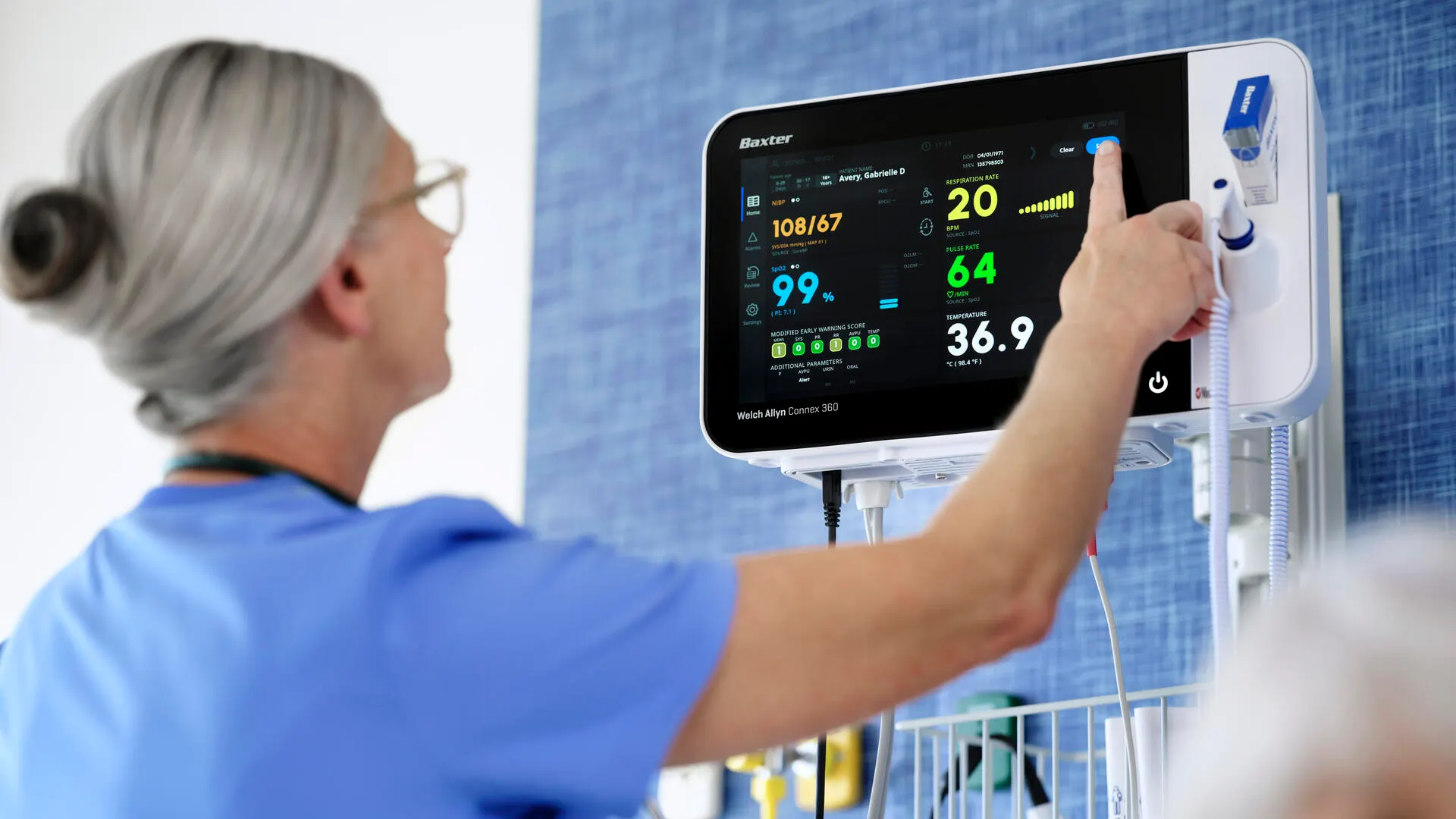 Healthcare checking vitals on the Connex 360 and patient