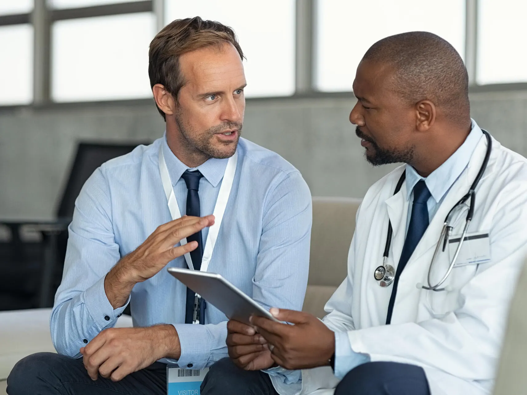 Sales representative and healcare provider talking