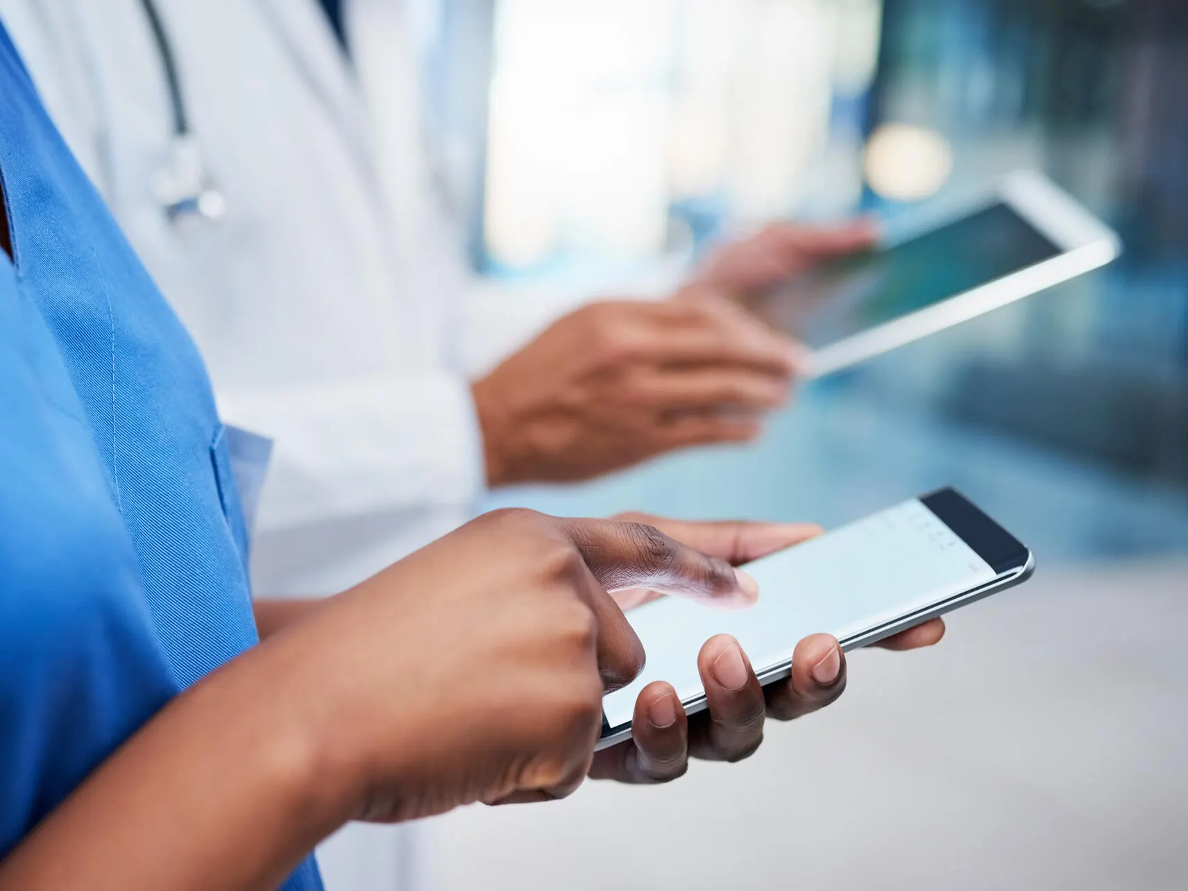 Healthcare profesionals reviewing material on their devices