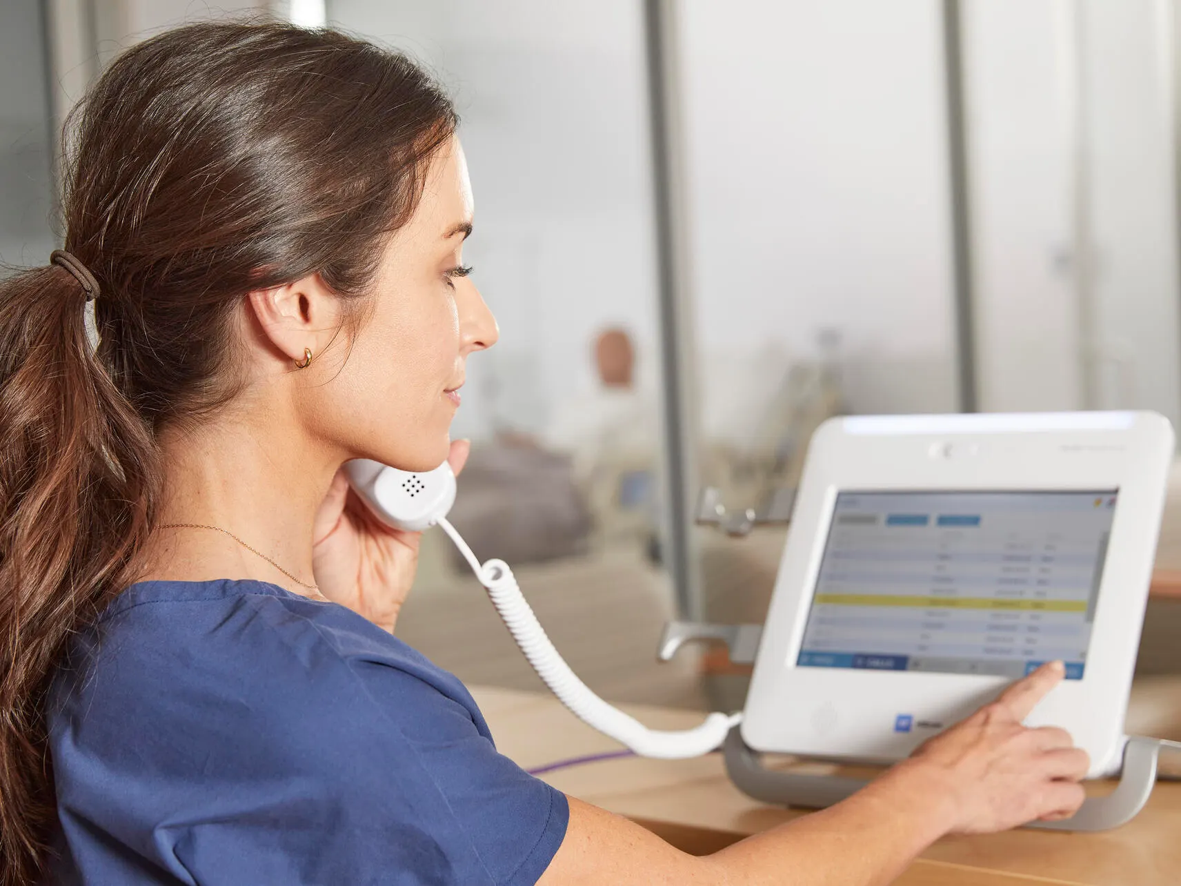 Nurse makes a telephone call using the Voalte Nurse Call device