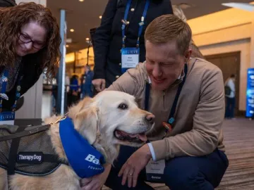 Baxter leaders petting Pet Partners therapy dog