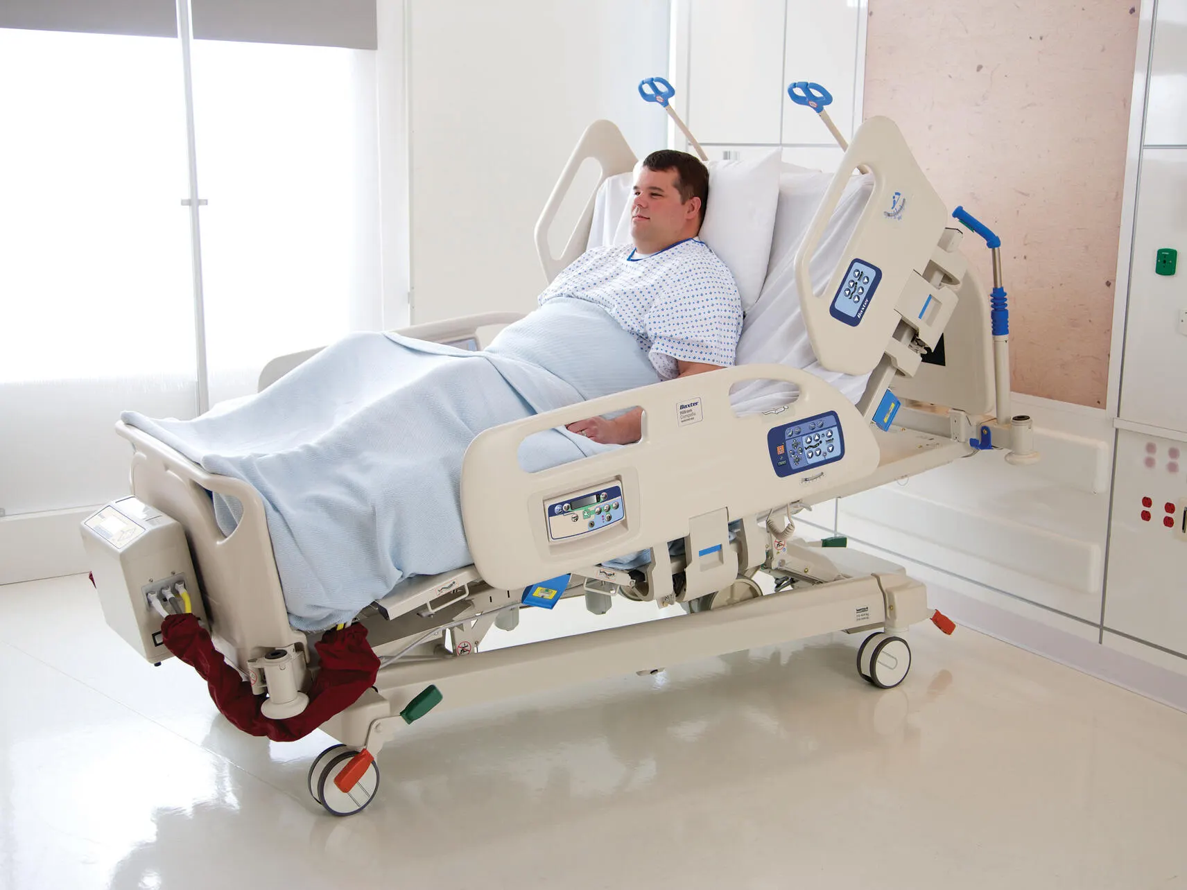 An obese patient sitting in a Compella bariatric bed in the upright position