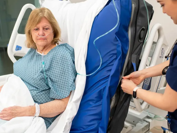 Healthcare worker adds an x-ray cassette to a Progressa+ bed