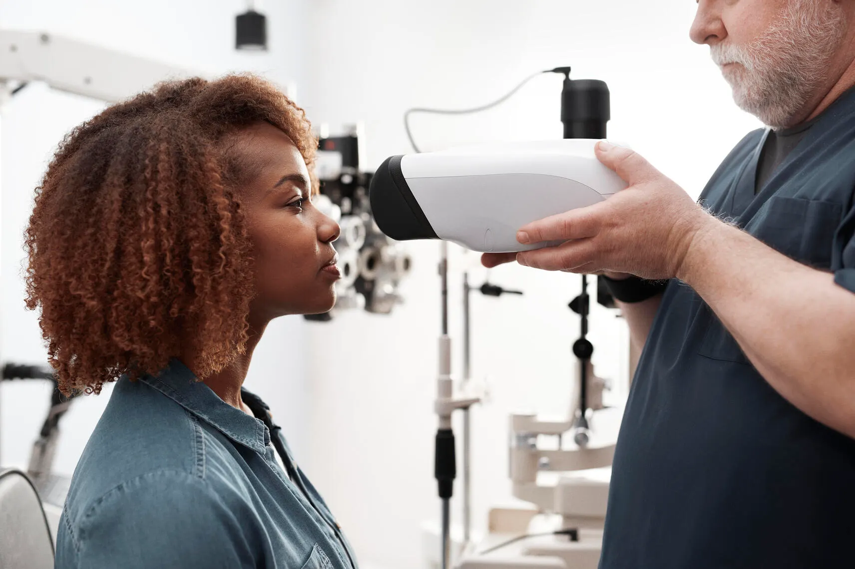 Patient getting eyes screened in ophthalmologist office with RetinaVue 700 imager