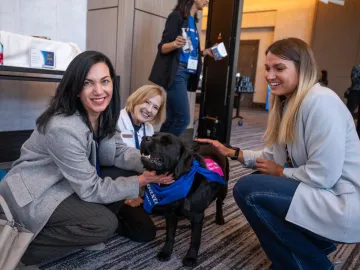 Baxter leaders and Pet Partners handler interacting with therapy dog