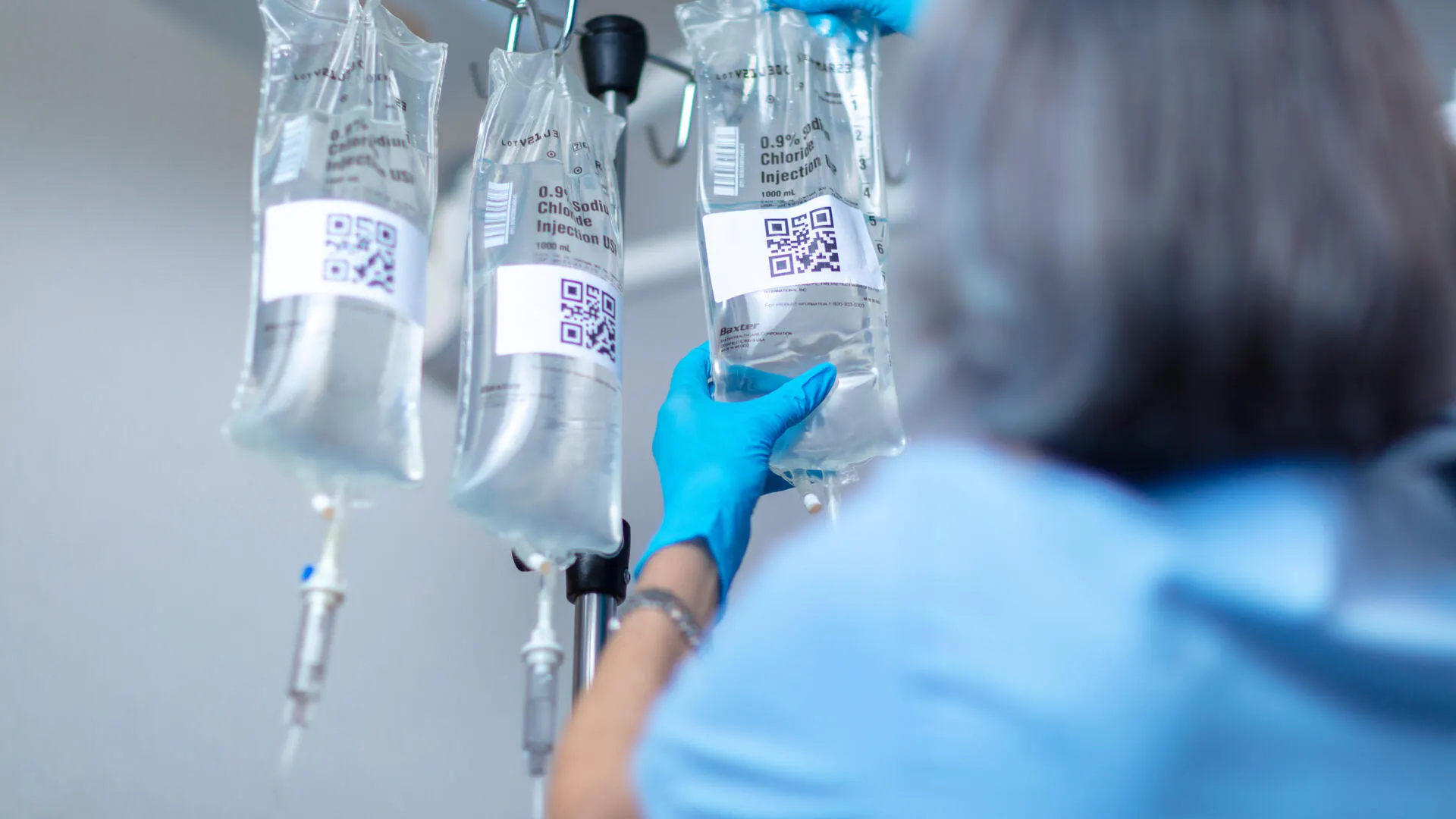 Nurse scanning Baxter IV bag on pole