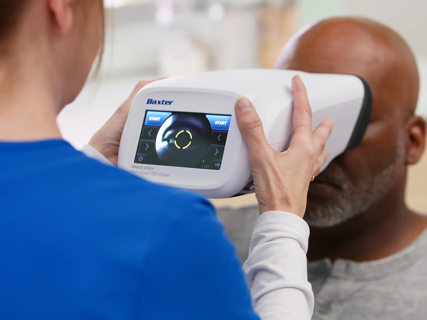 Clinician conducting a retinal exam on a patient with the Retinavue 700