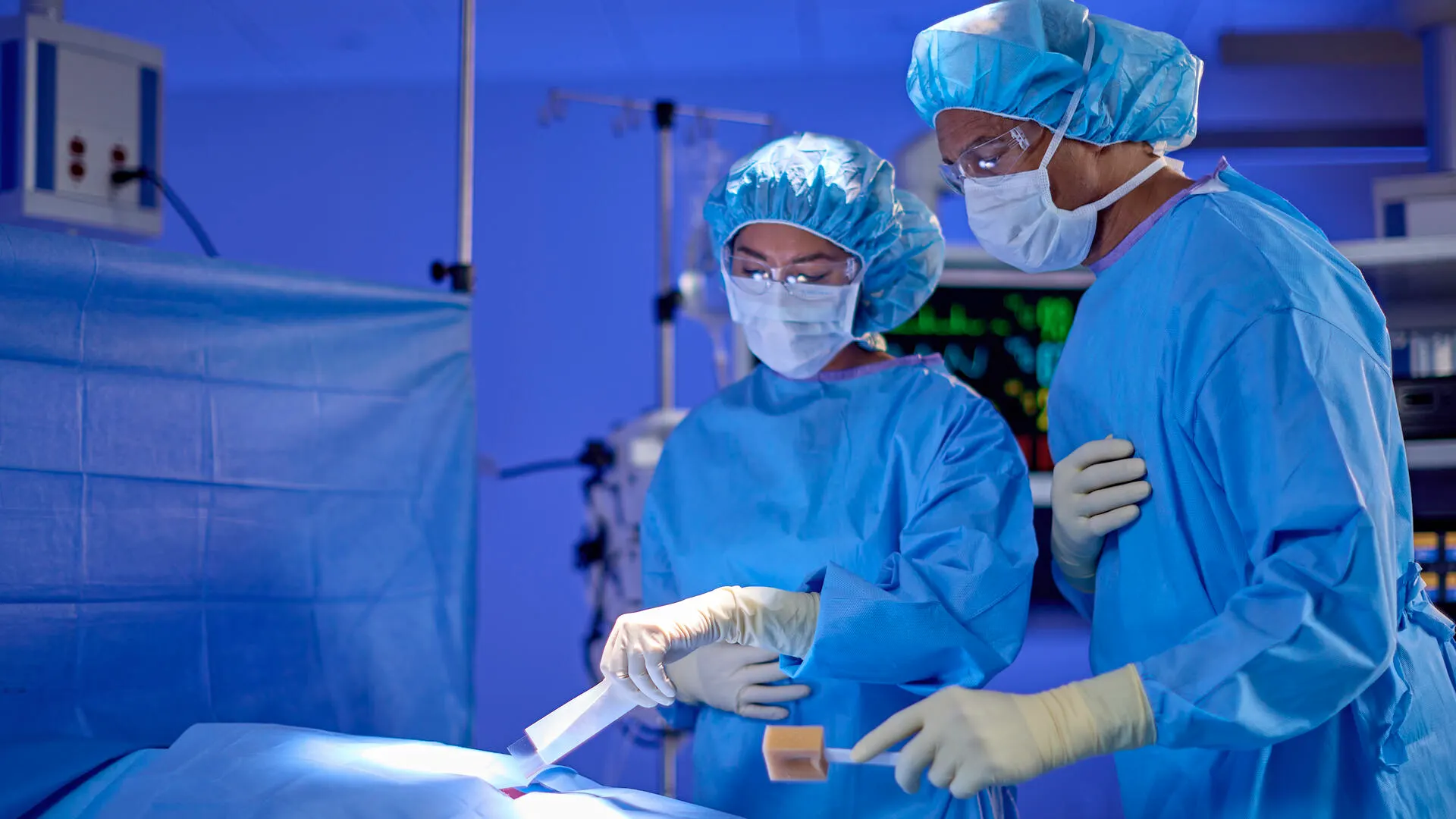 Two surgeons using Seprafilm Adhesion Barrier during an operation.